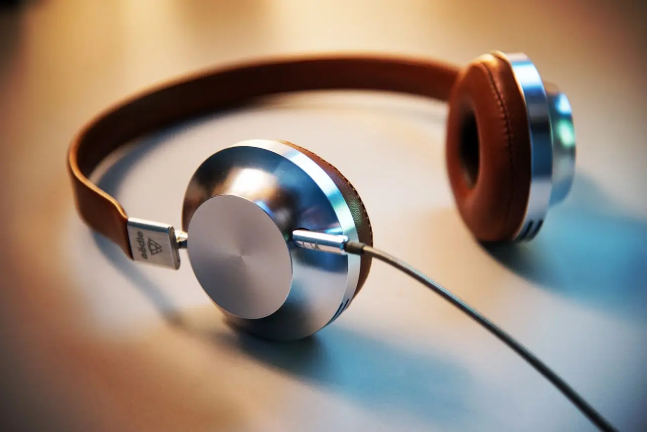 Wireless headphones beside a laptop
