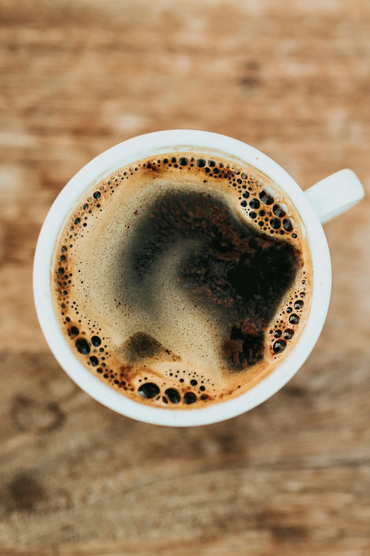 Coffee cup near a laptop keyboard