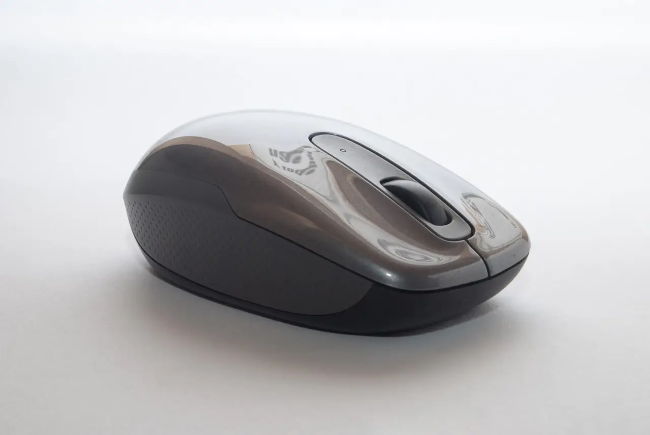 Laptop on a desk with wireless accessories nearby