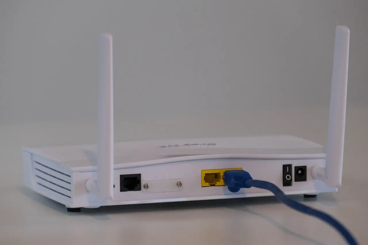 Person holding a smartphone near a wireless router